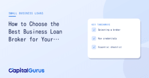 Small business owner and business loan broker reviewing loan documents together in a bright, modern office